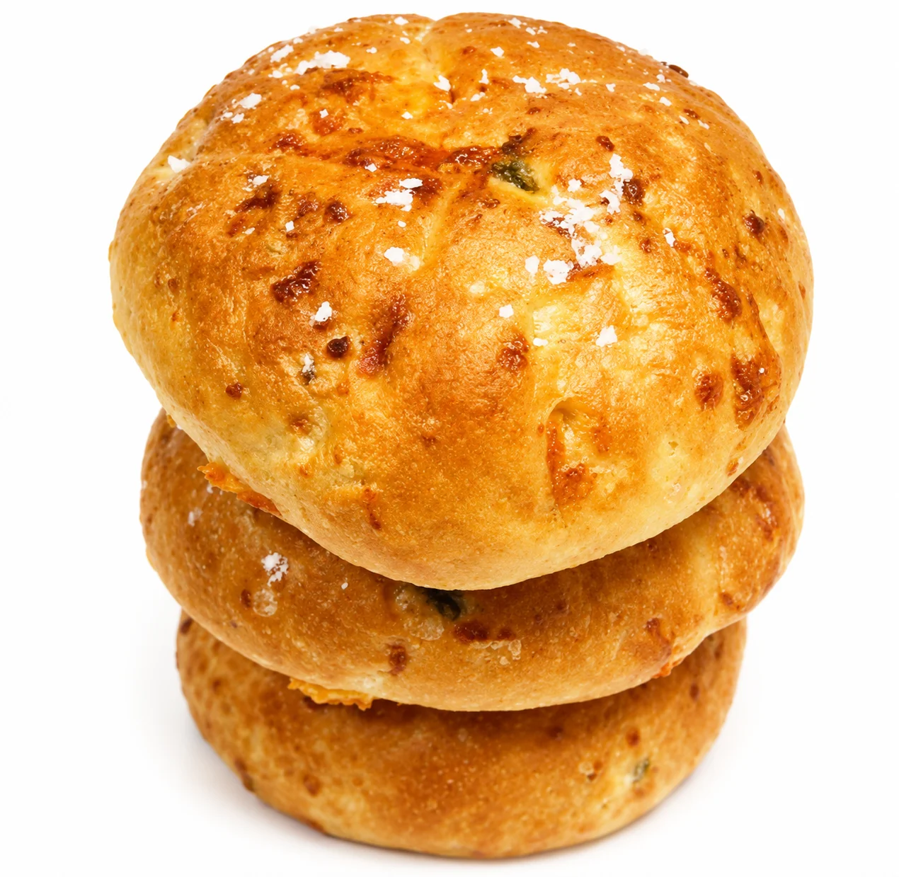 Three golden, flaky bread rolls stacked on top of each other.