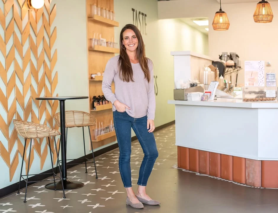 Welcoming restaurant interior with modern decor and a smiling staff member