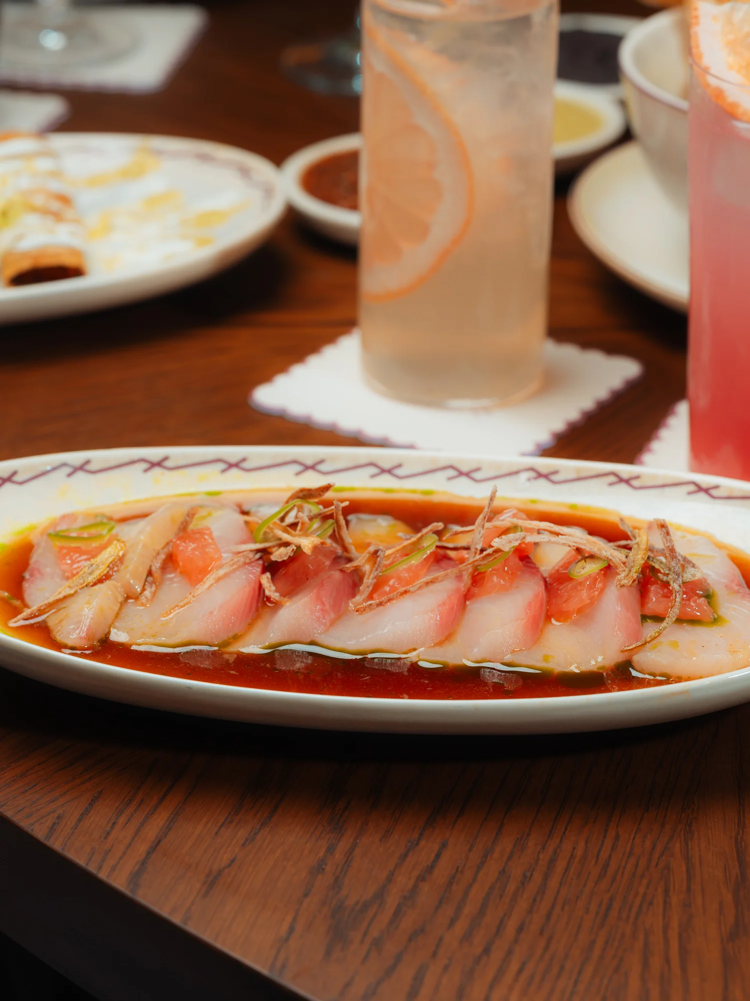 Sashimi platter with vibrant fish and sauce, showcasing Japanese cuisine