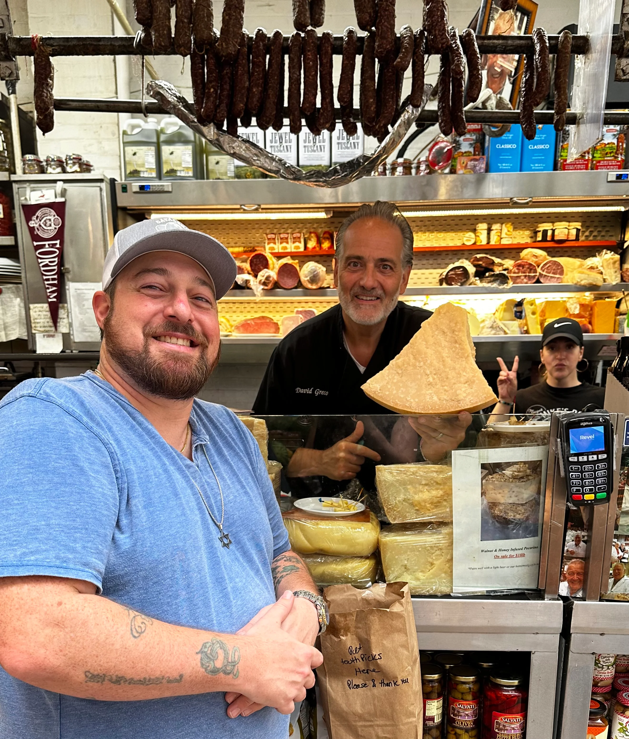 Cheese display at a deli with friendly staff