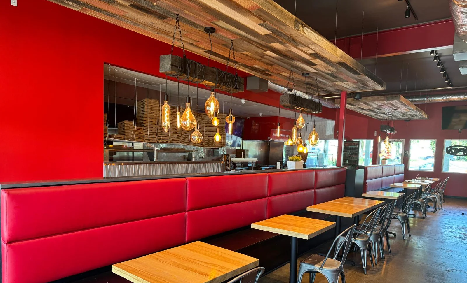 Modern restaurant interior with red walls and stylish lighting fixtures