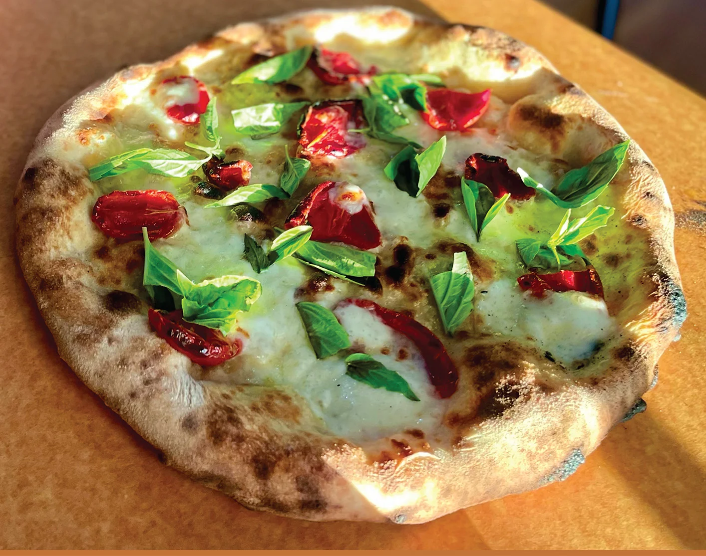 Margherita pizza with fresh basil and sun-dried tomatoes