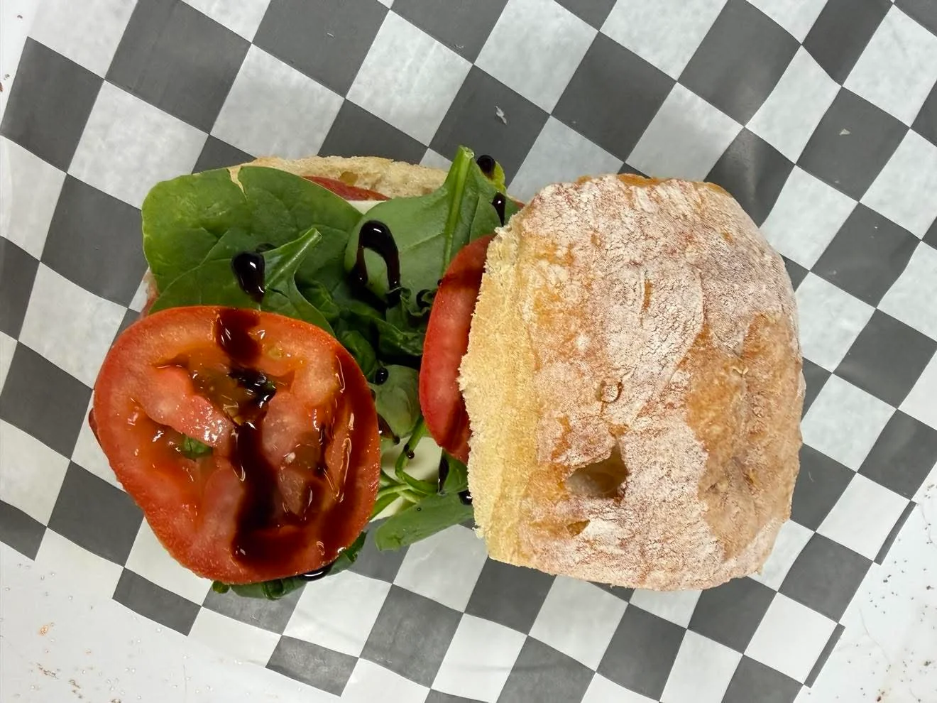 Fresh Italian ciabatta sandwich with greens and tomatoes