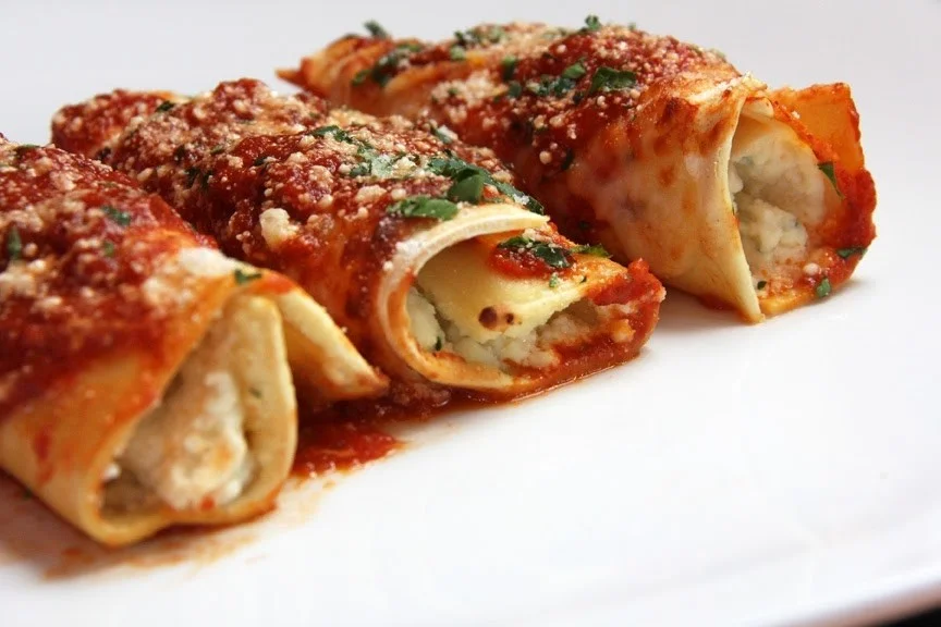 Italian cannelloni filled with ricotta and marinara sauce
