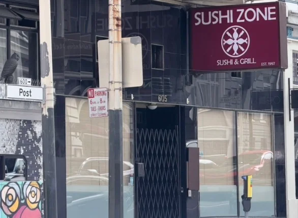 Exterior view of Sushi Zone restaurant with signage and street details