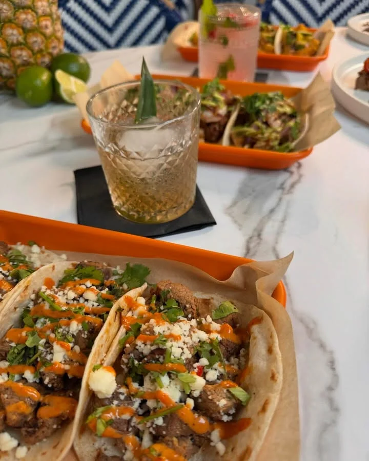 Delicious Mexican tacos topped with cilantro and spicy sauce
