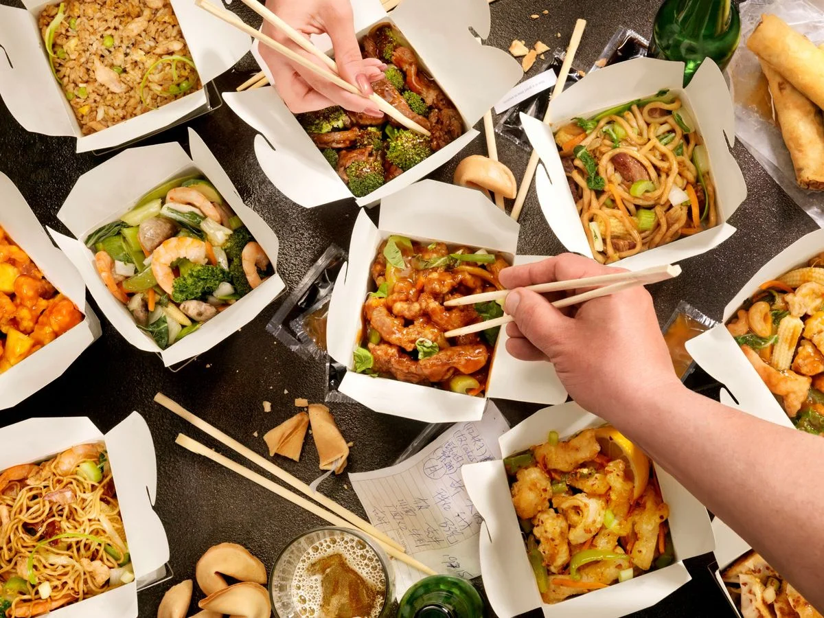 Assorted Chinese takeout dishes with chopsticks