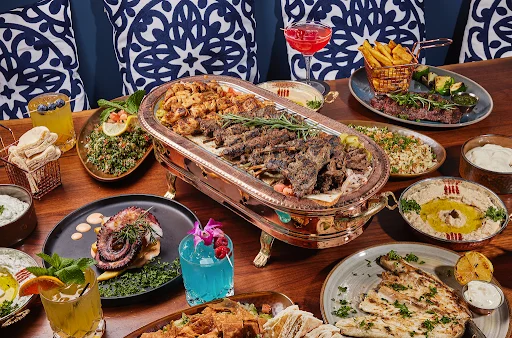 Lavish Middle Eastern mixed grill platter with vibrant sides
