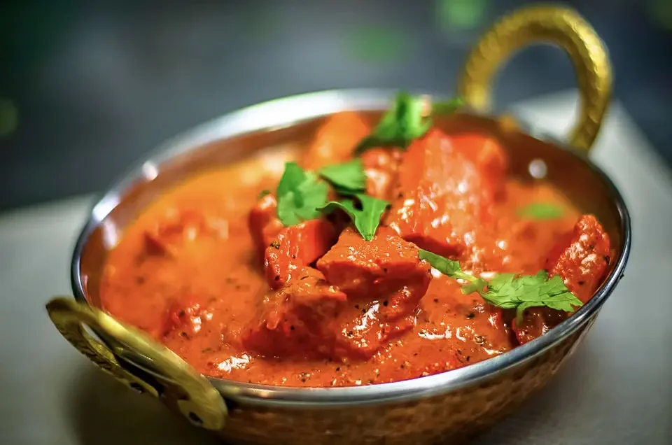 Creamy Indian butter chicken in a traditional serving bowl