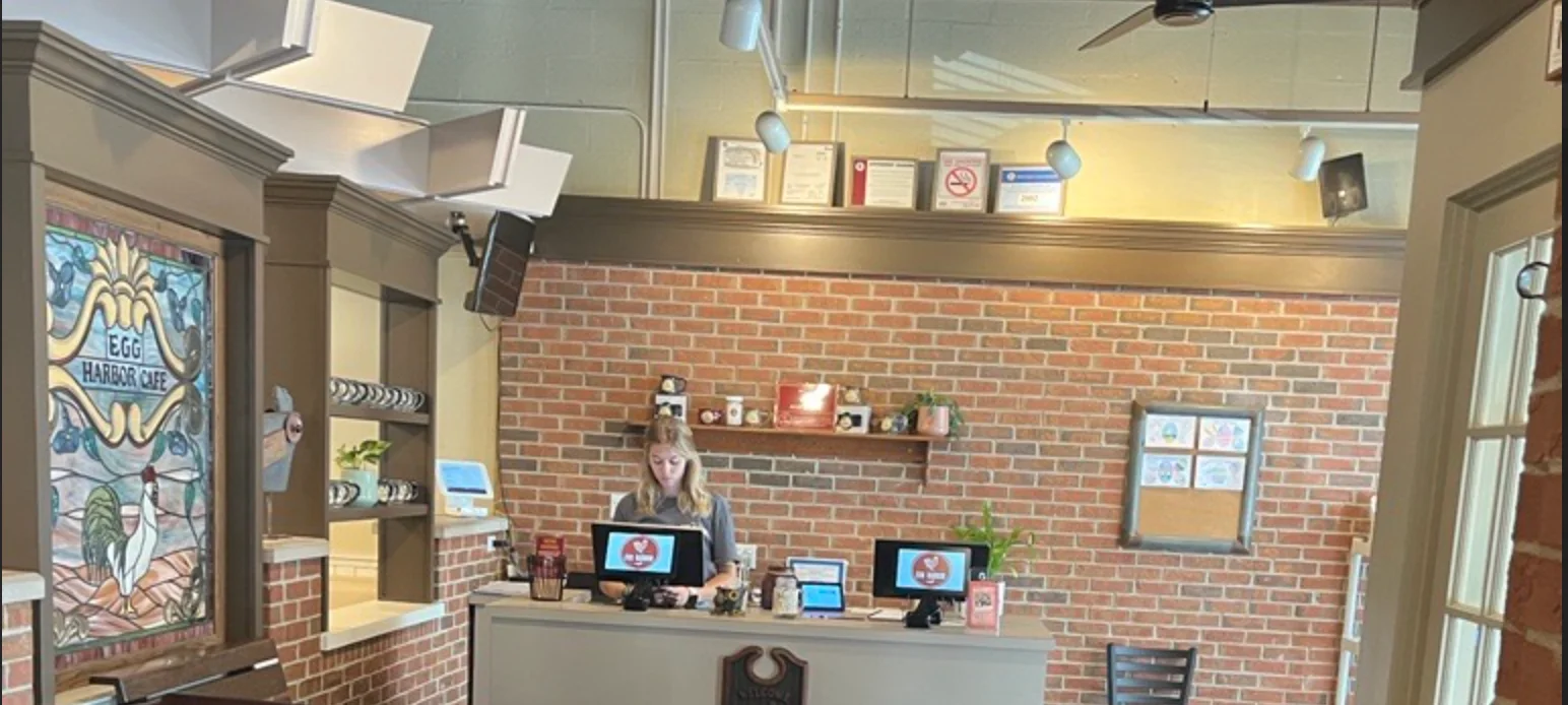 Cozy restaurant reception area with brick walls and welcoming decor