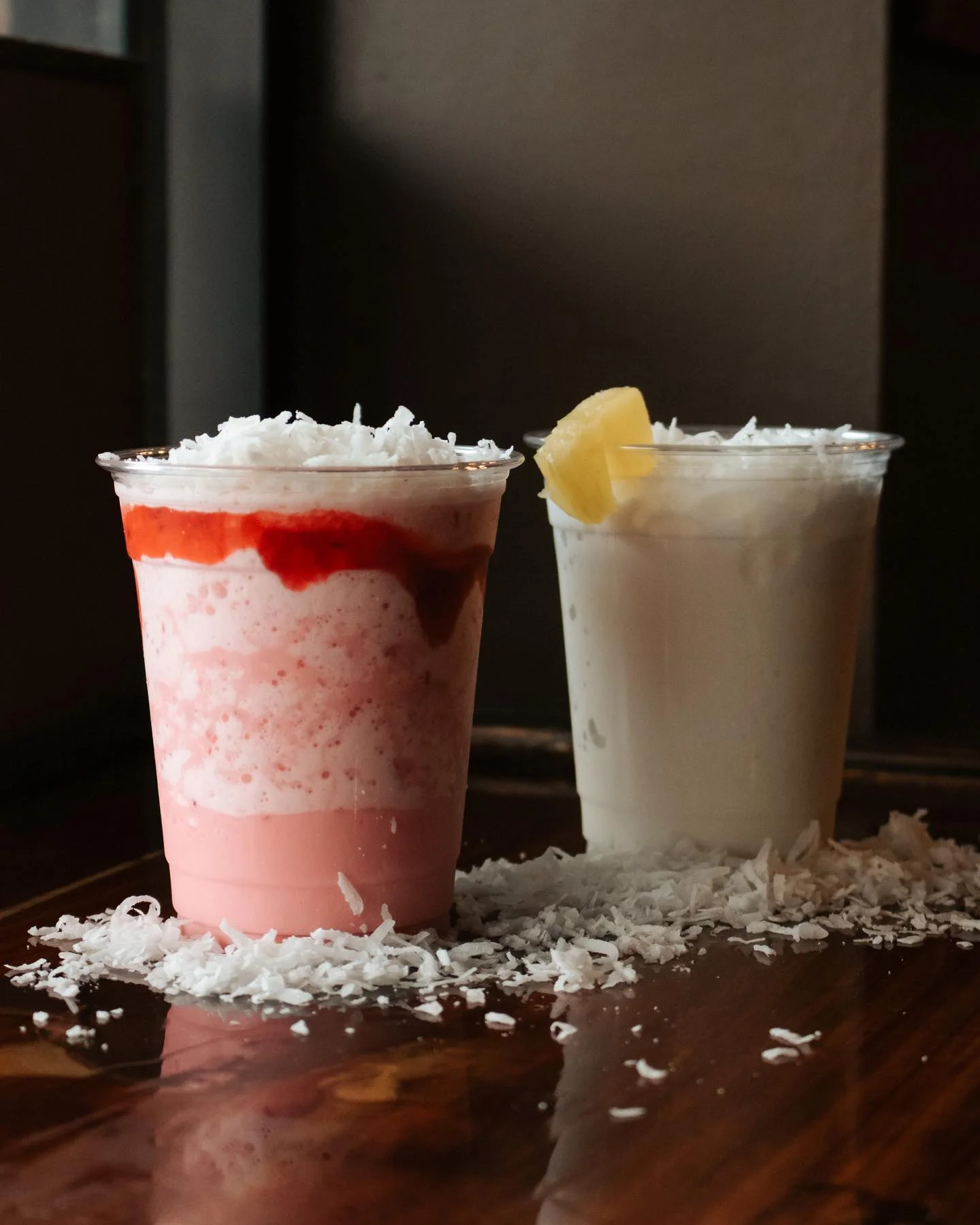 Refreshing coconut and strawberry drinks with shredded coconut topping