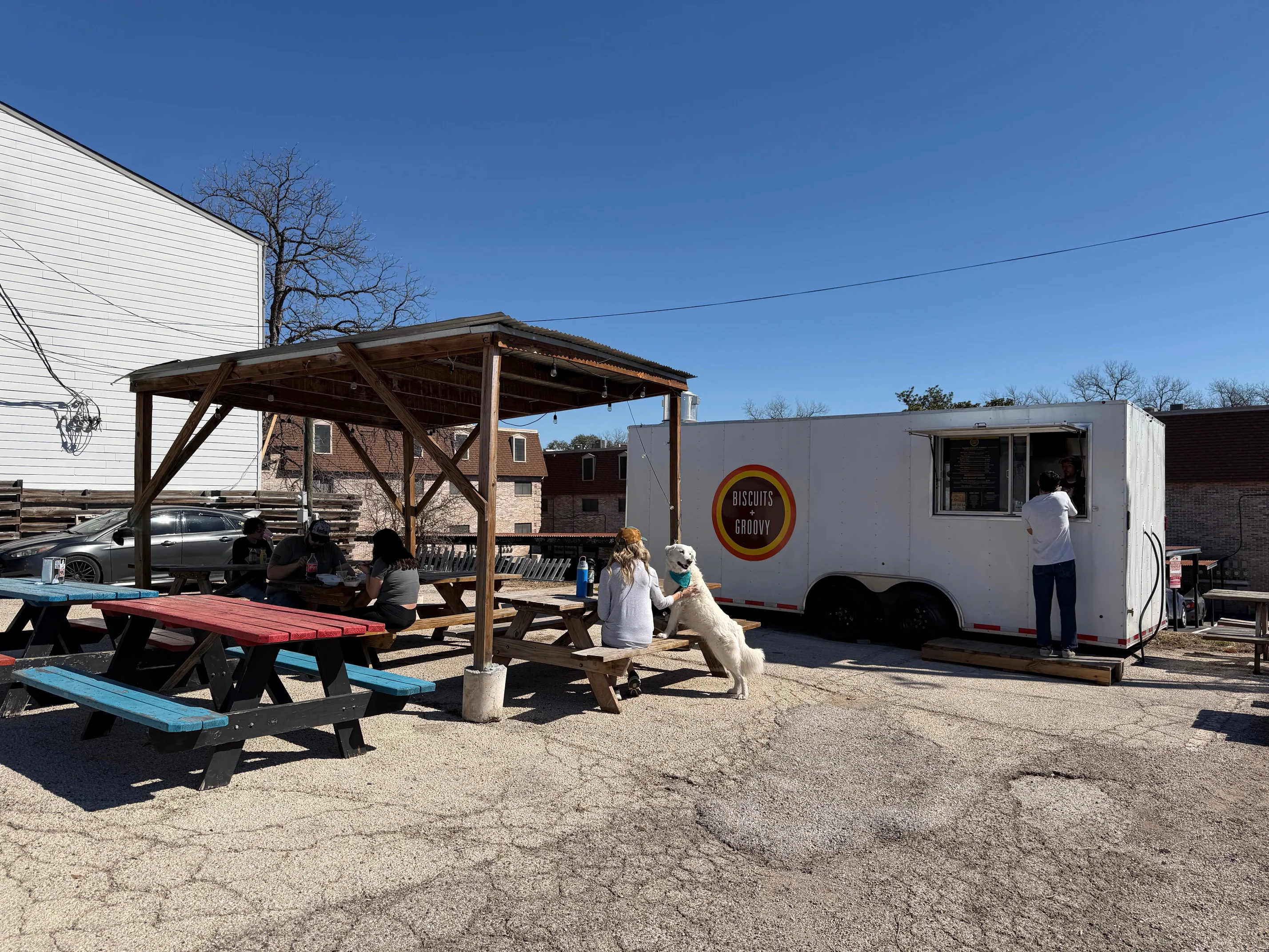 Food truck serving biscuits in a vibrant outdoor seating area