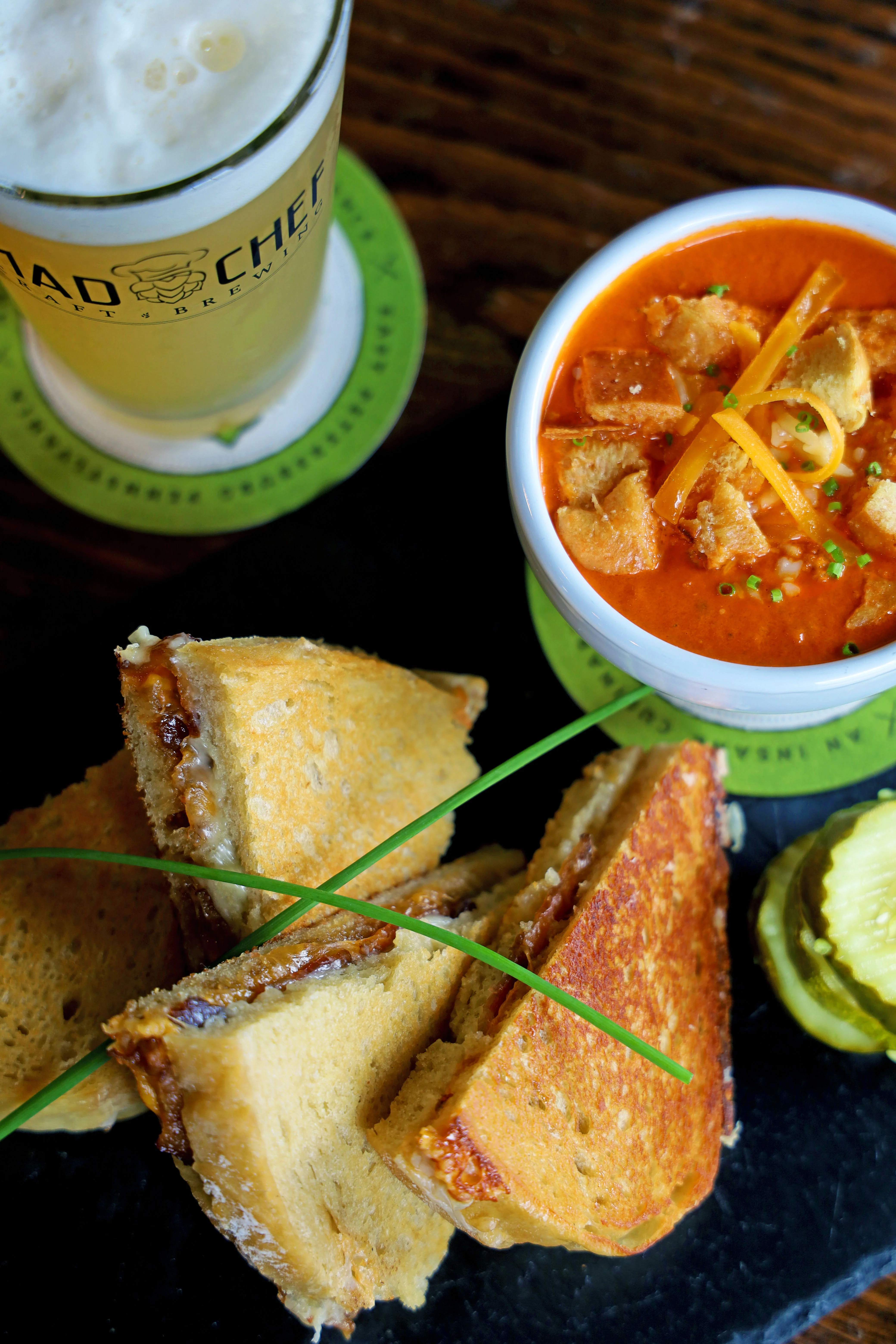 Grilled cheese sandwich with tomato soup in a cozy restaurant setting