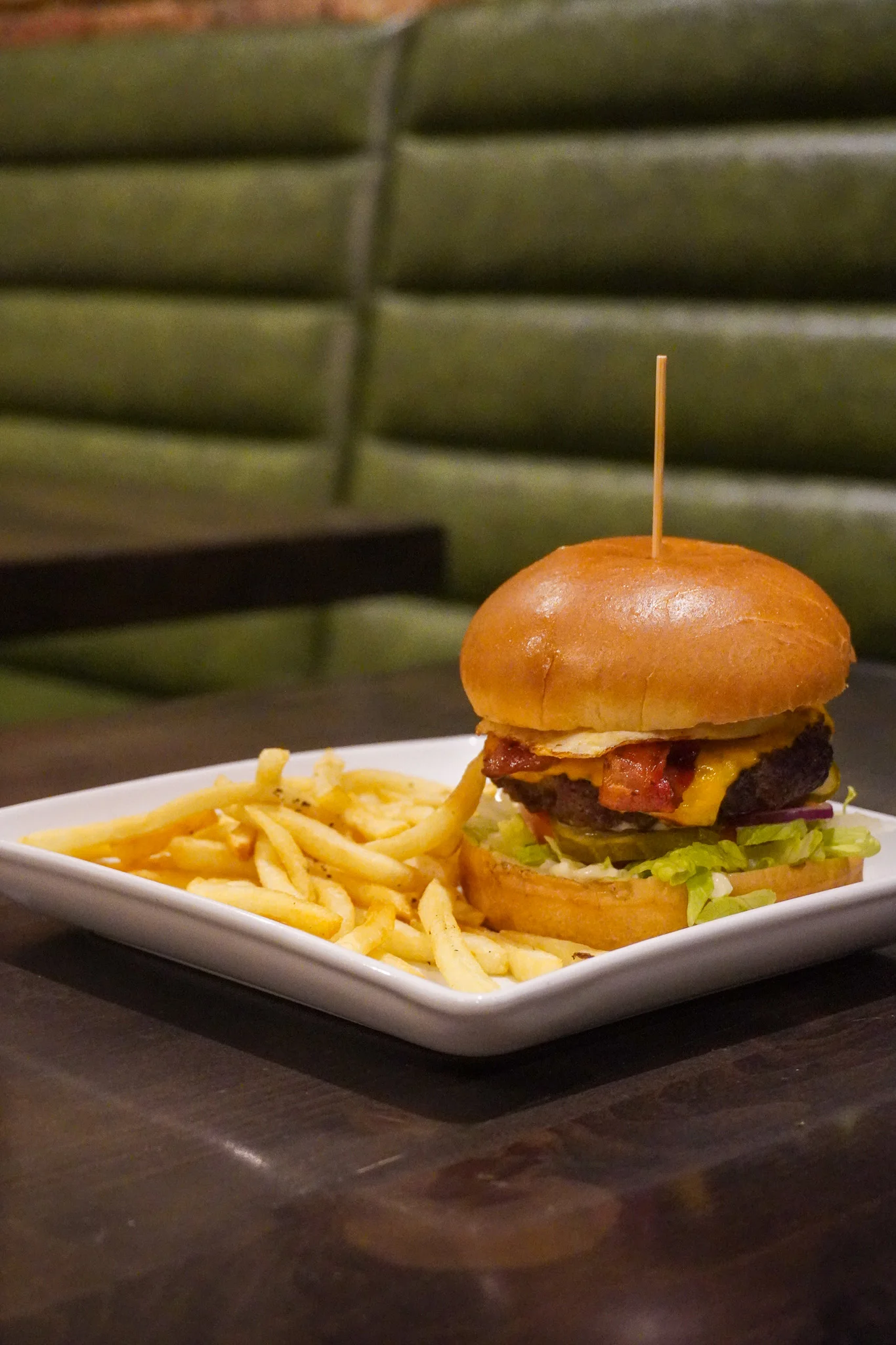 Juicy cheeseburger with fries in a cozy restaurant setting