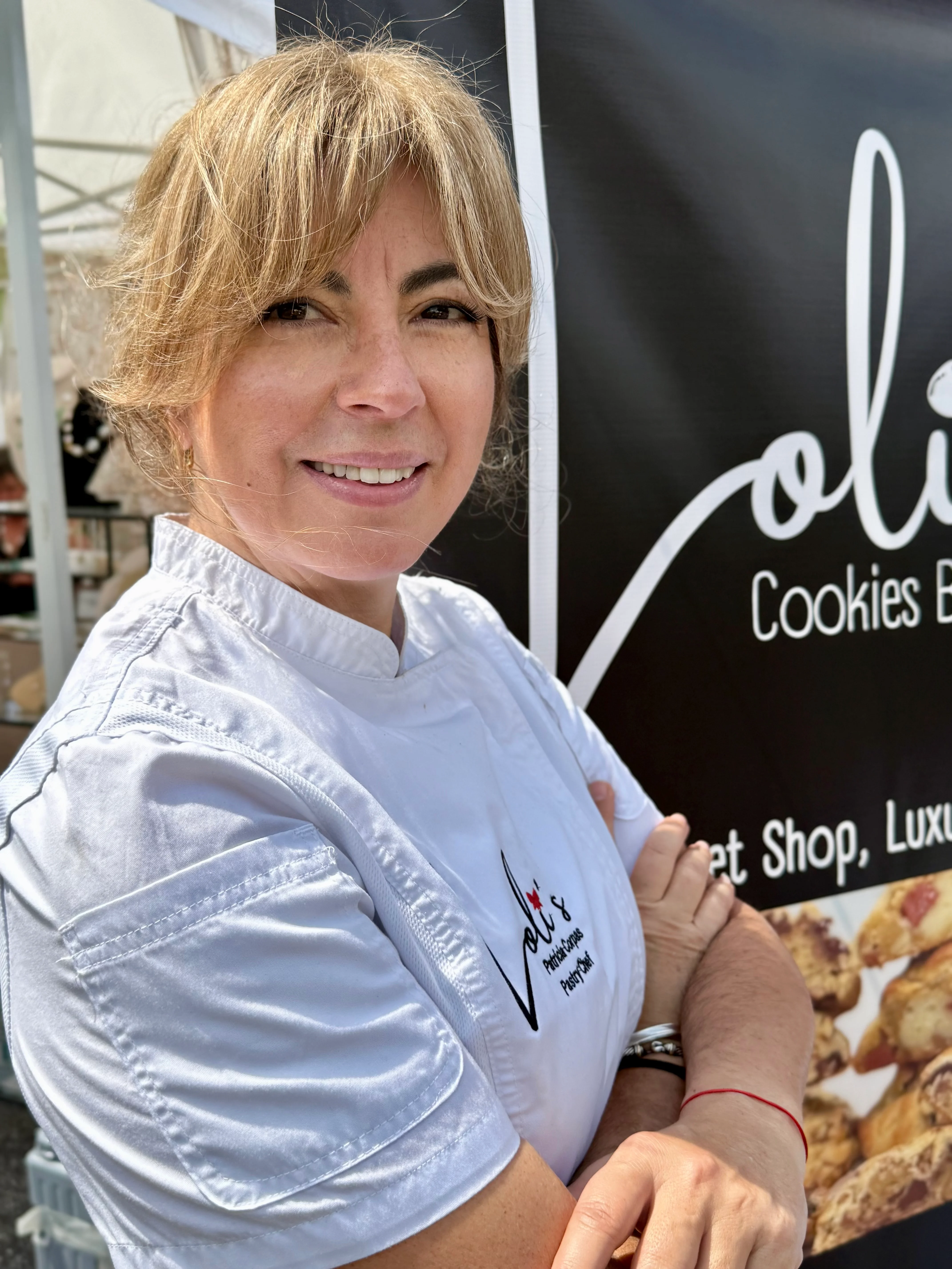 Chef at a cookie booth showcasing gourmet treats