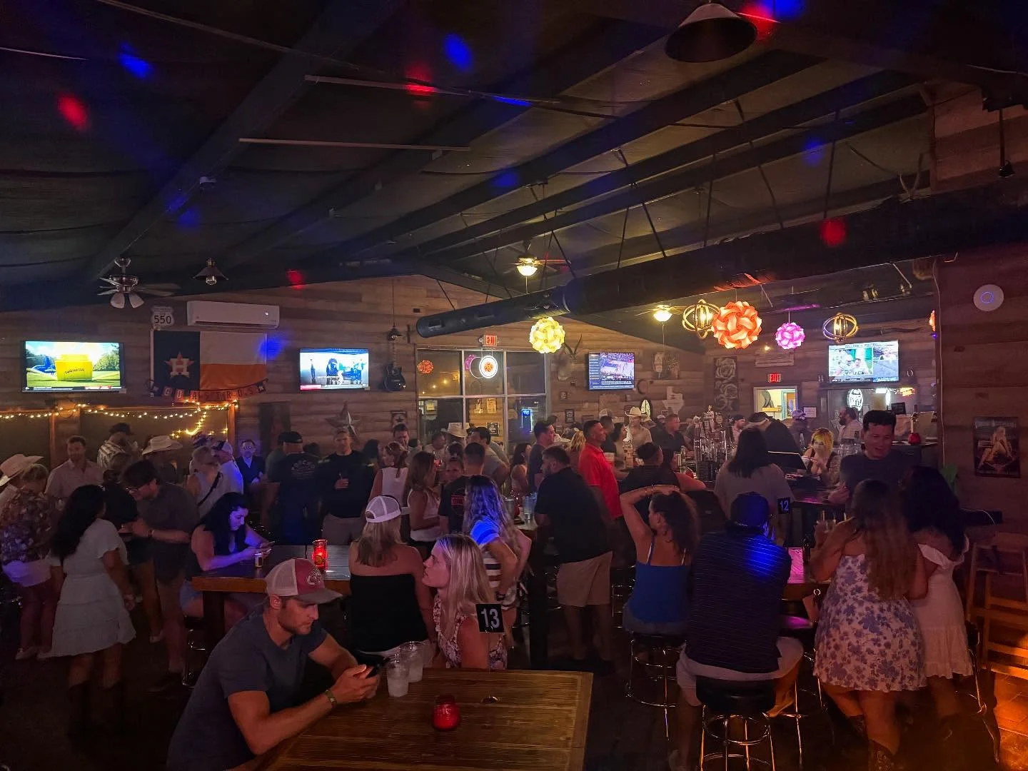 Lively bar scene with patrons enjoying drinks and socializing