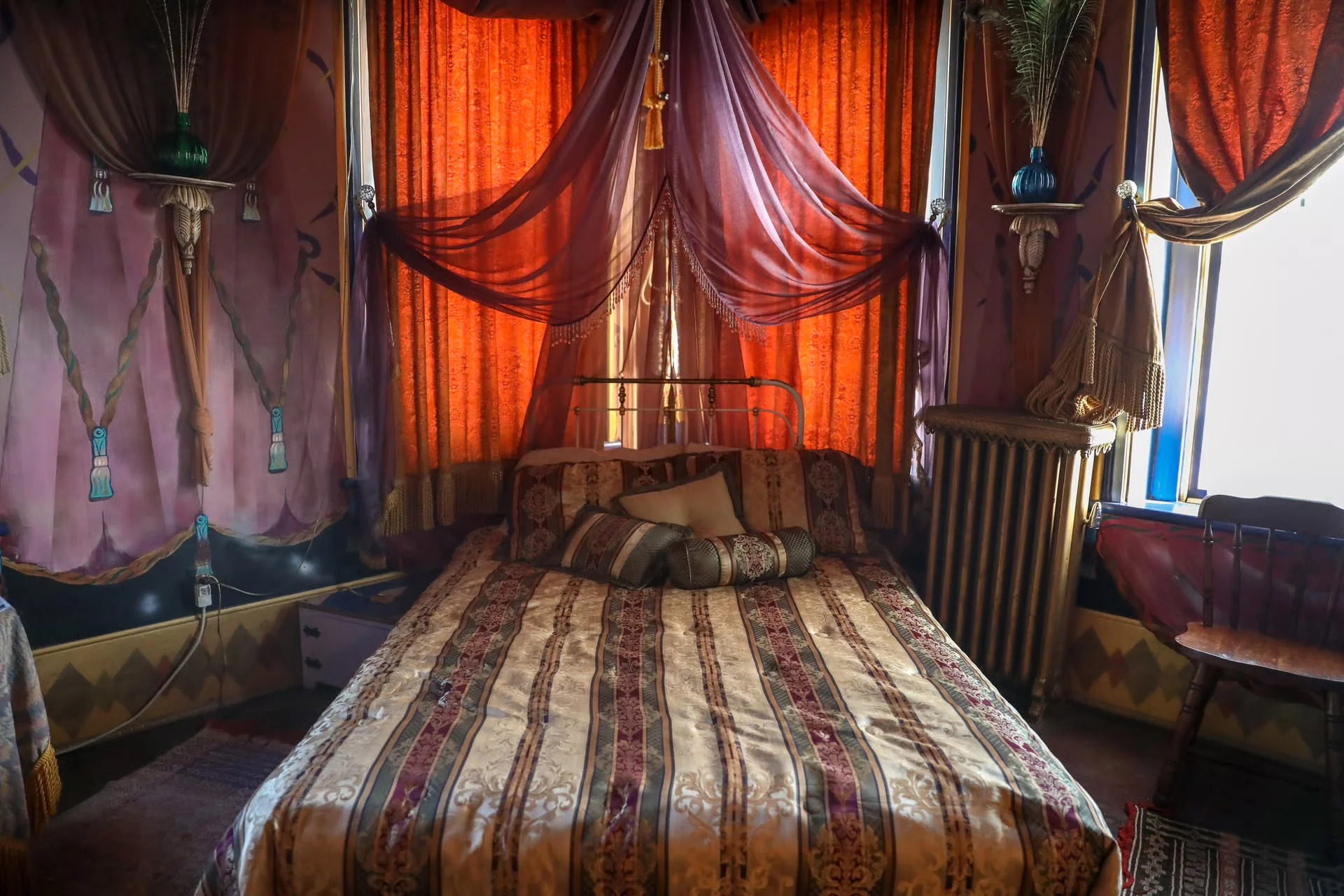 Cozy bedroom with vibrant curtains and ornate decor
