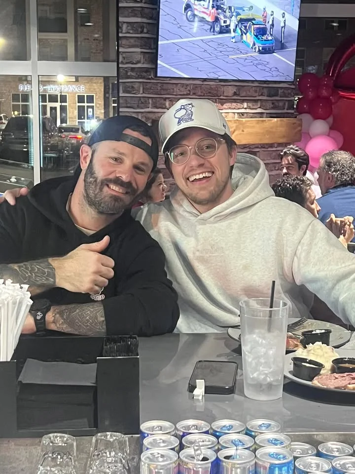 Two friends enjoying a meal at a lively restaurant