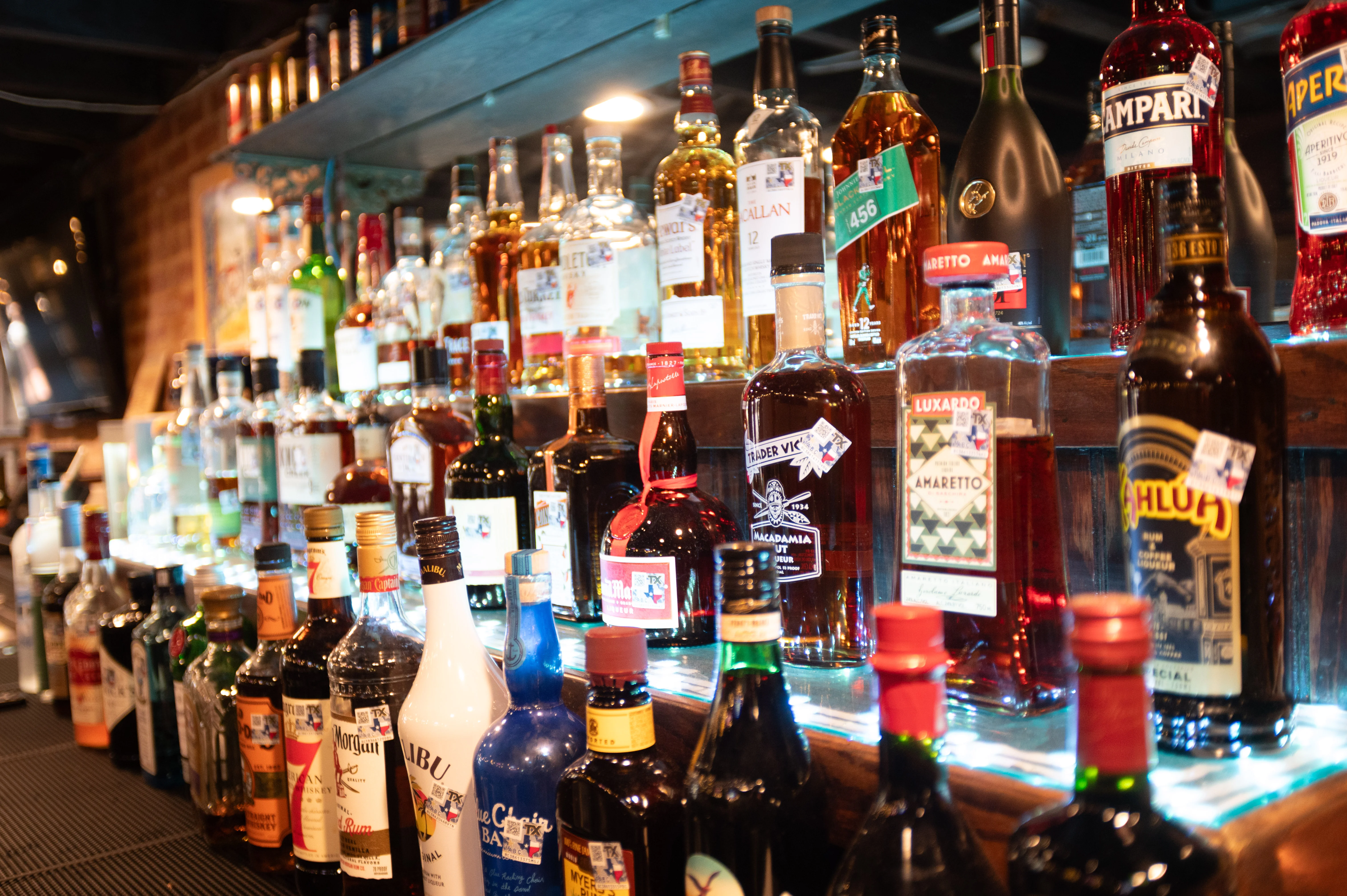 Well-stocked bar with various spirits and liquors