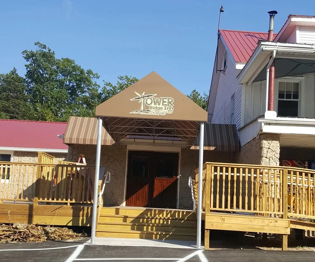 Entrance of Tower Ridge Inn with wooden deck and signage