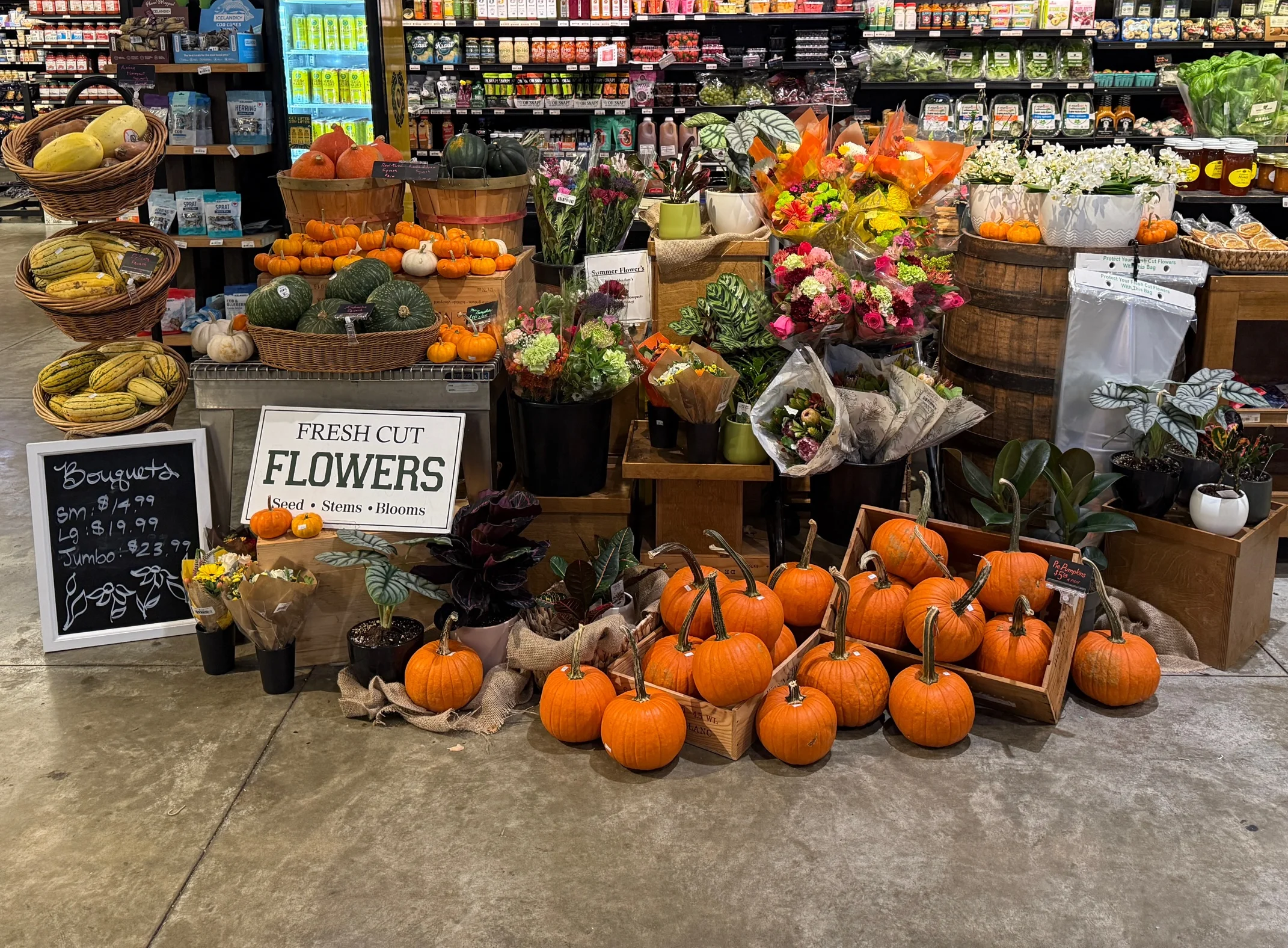 Brightly lit grocery store produce section with fresh fruits and vegetables