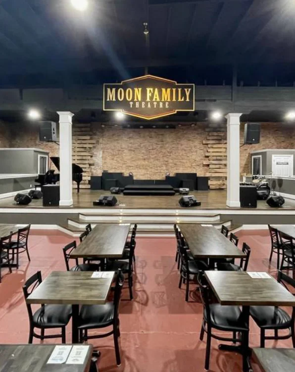 Interior of Moon Family Theatre with tables and stage setup for events