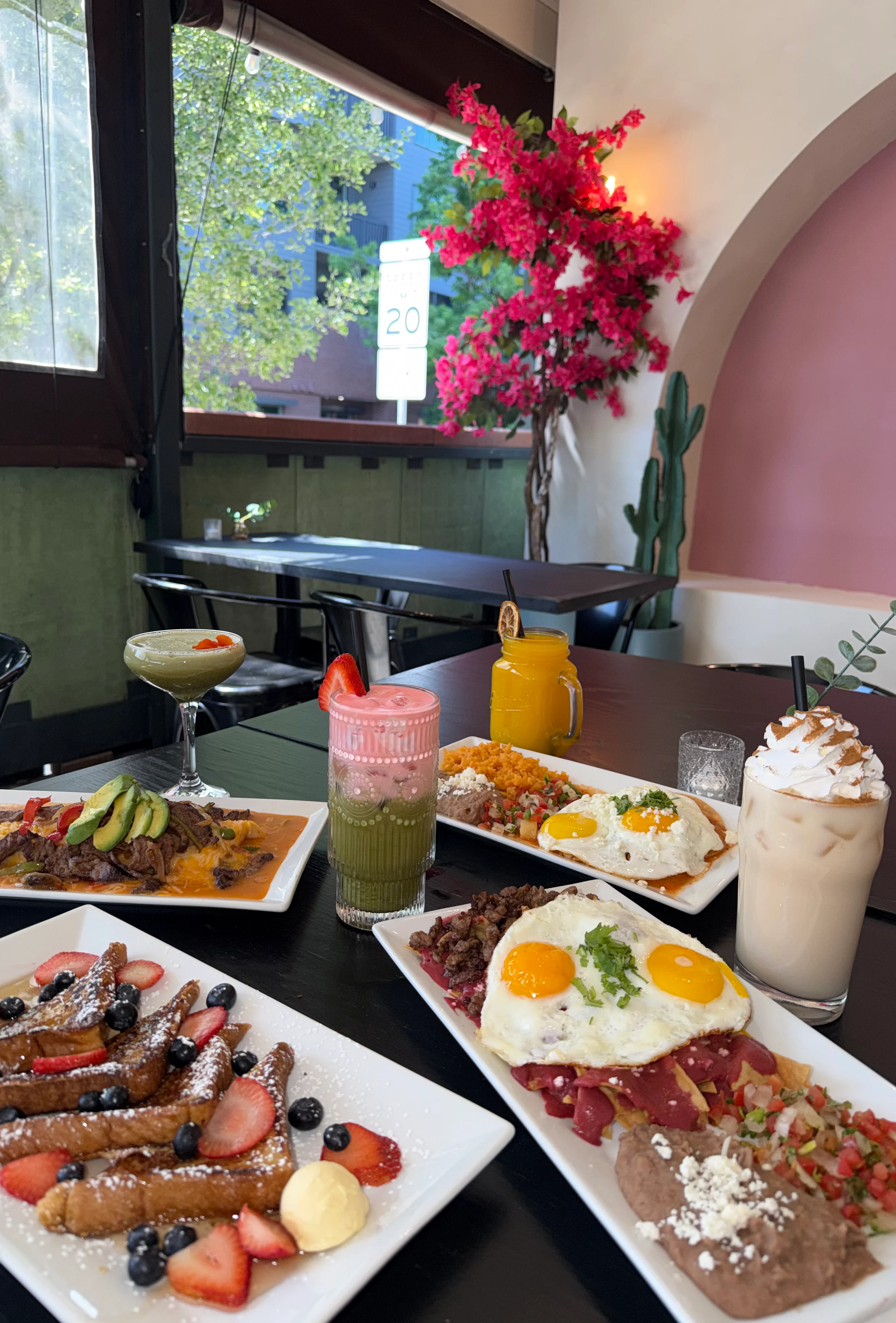 Colorful Mexican brunch spread with huevos rancheros and French toast
