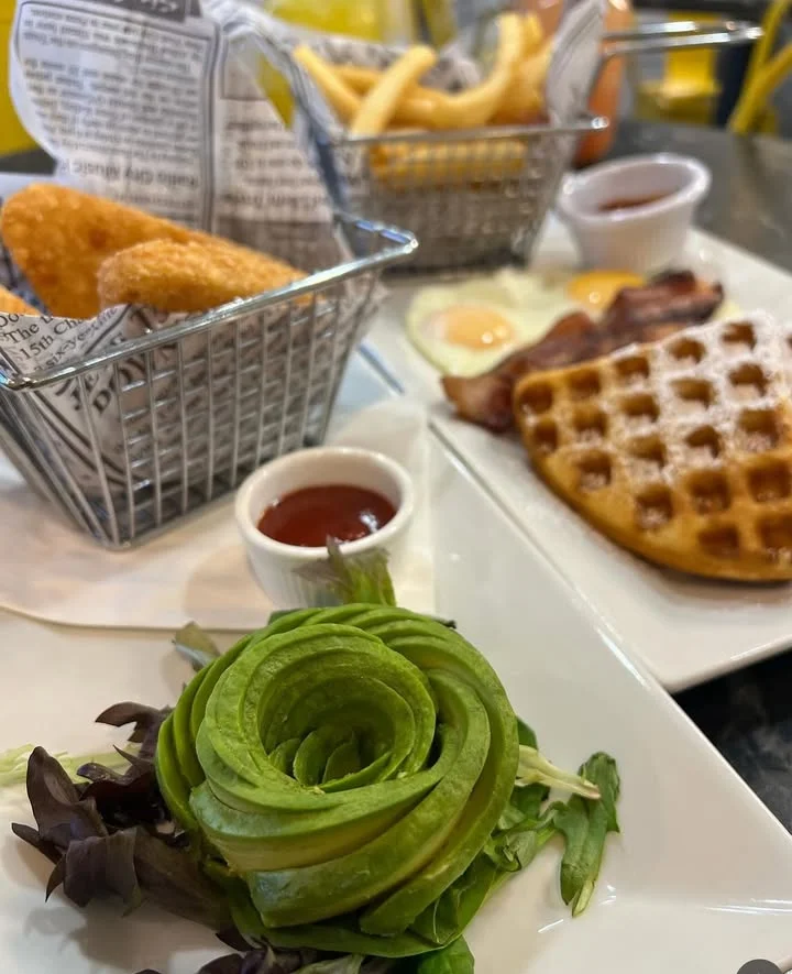 Classic American breakfast with waffles, eggs, and bacon