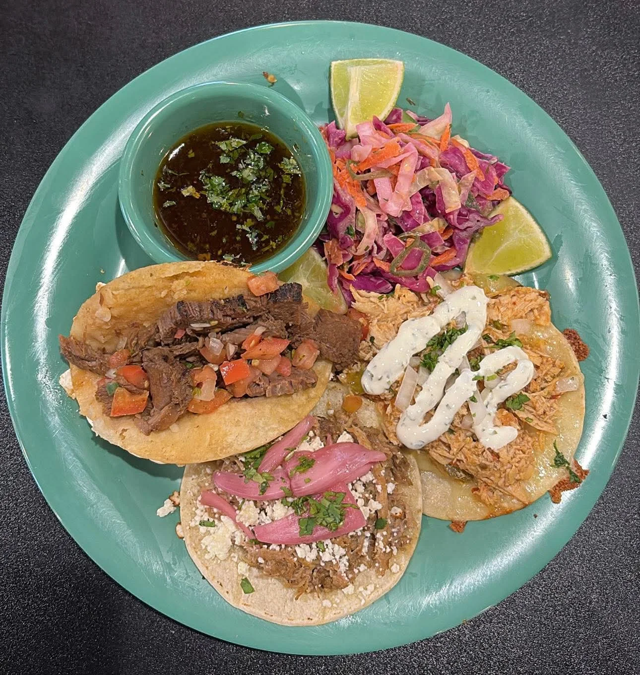 Assorted Mexican tacos with salsas and sides