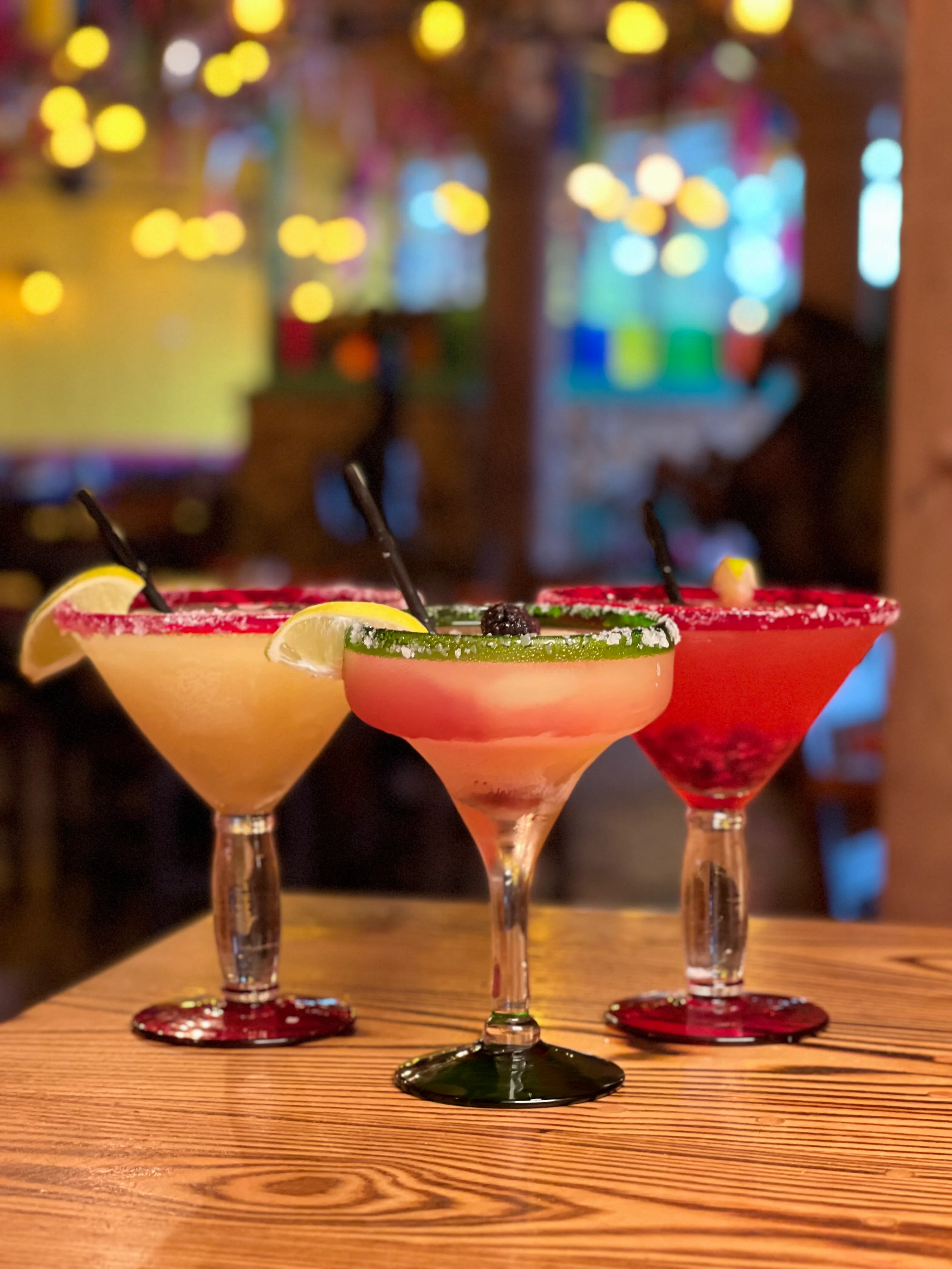 Colorful margaritas served in a vibrant restaurant setting