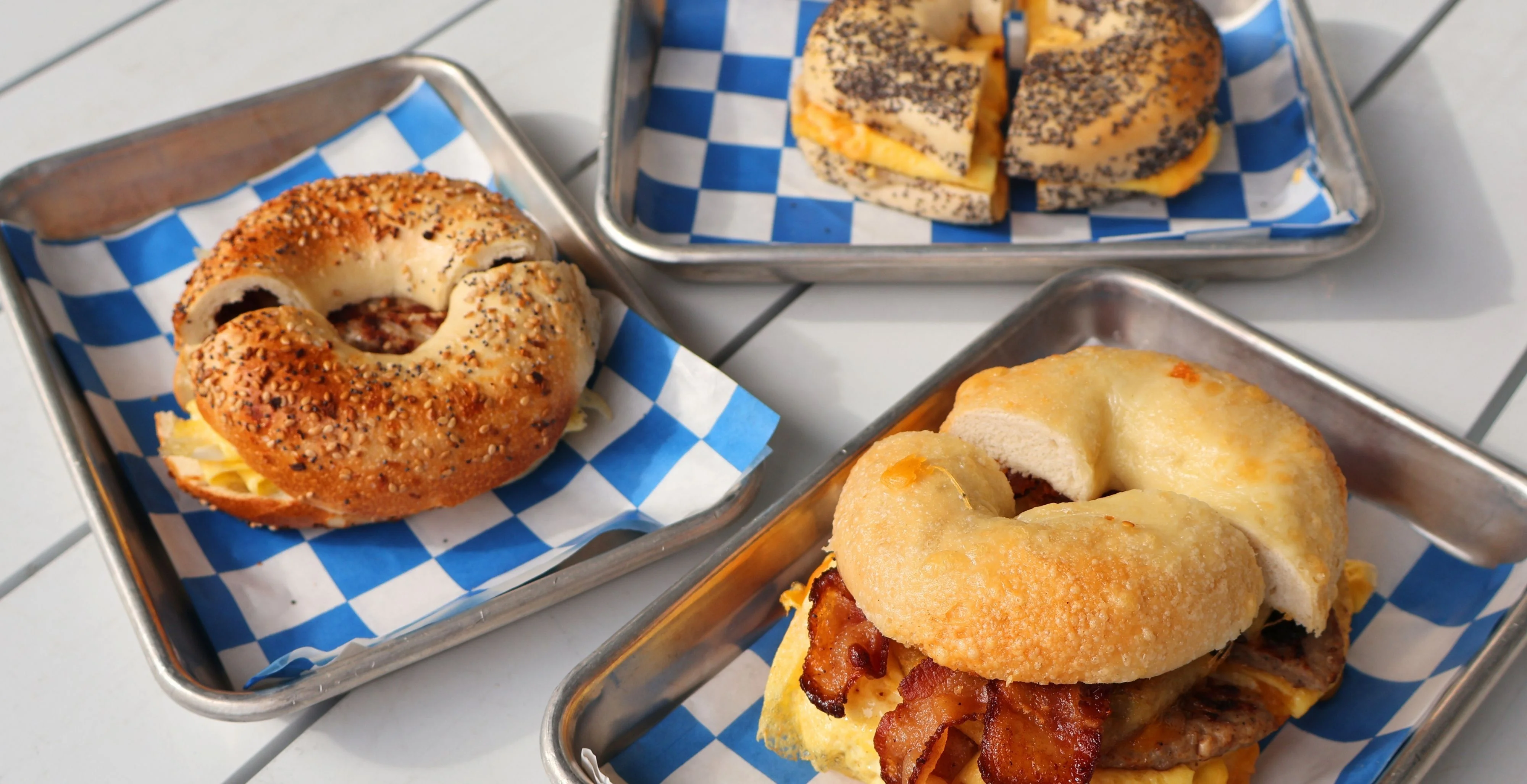 New York style bagel sandwiches with bacon egg and cheese served fresh on trays at nosh NY bagels Ridgeland