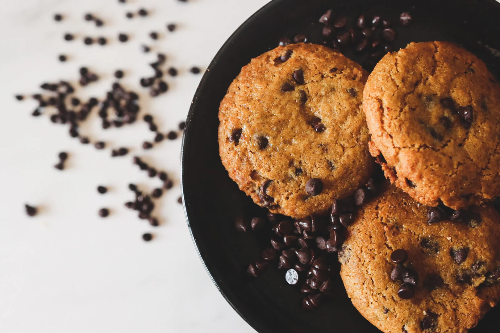 Delicious chocolate chip cookie on a white plate