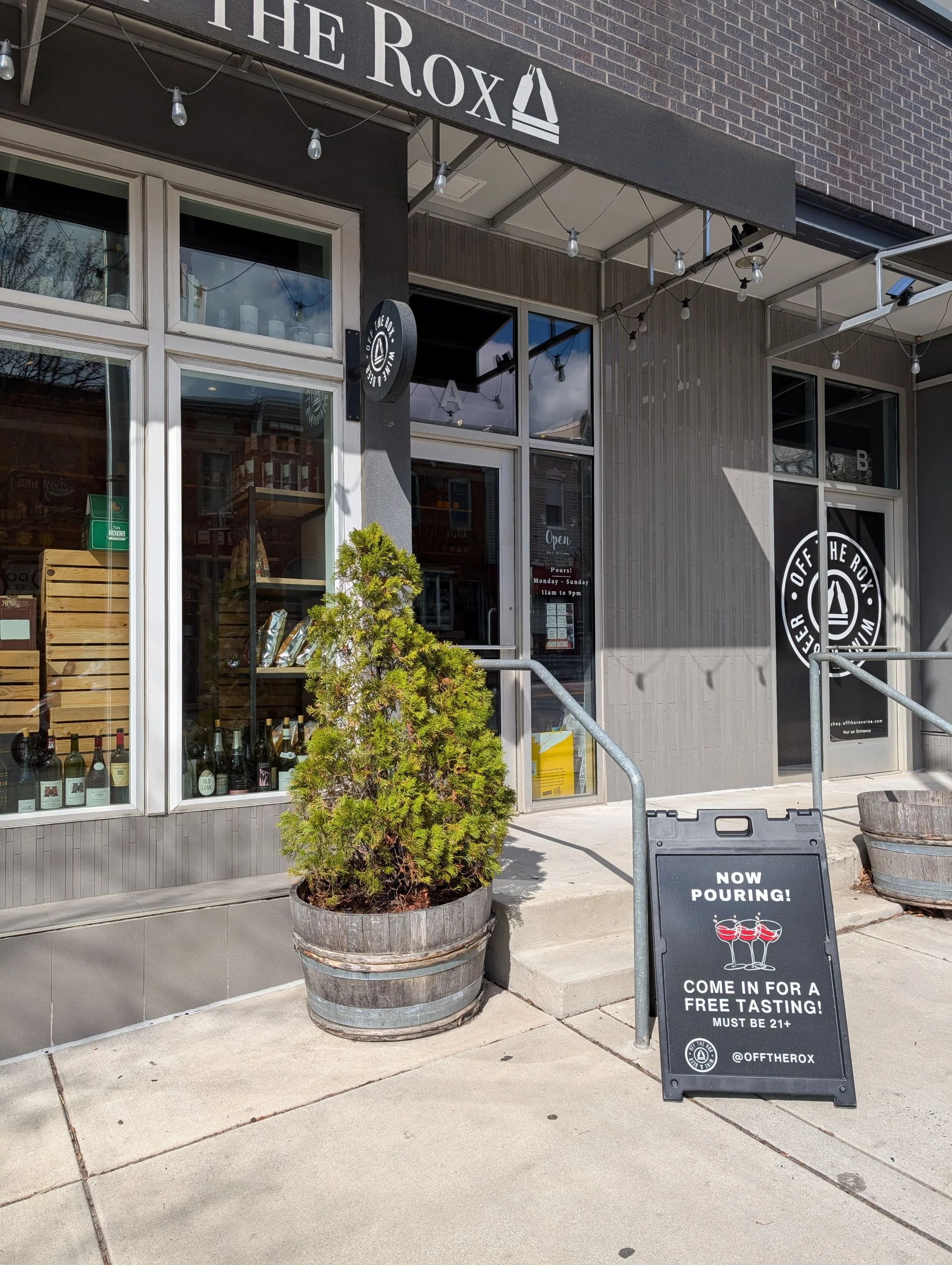 Exterior view of Off The Rox restaurant with tasting sign