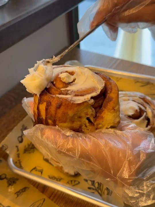 Freshly iced cinnamon roll ready to enjoy