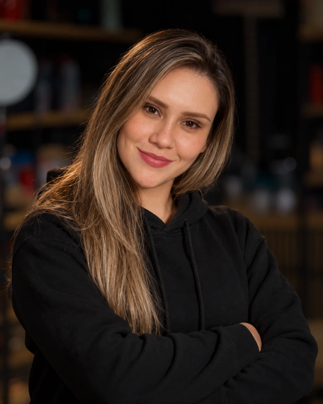 Professional portrait of a smiling woman in a restaurant interior