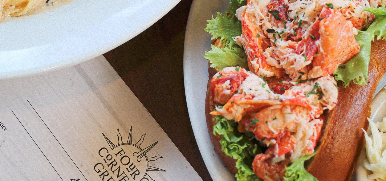 Lobster roll and seafood pasta in a cozy restaurant setting