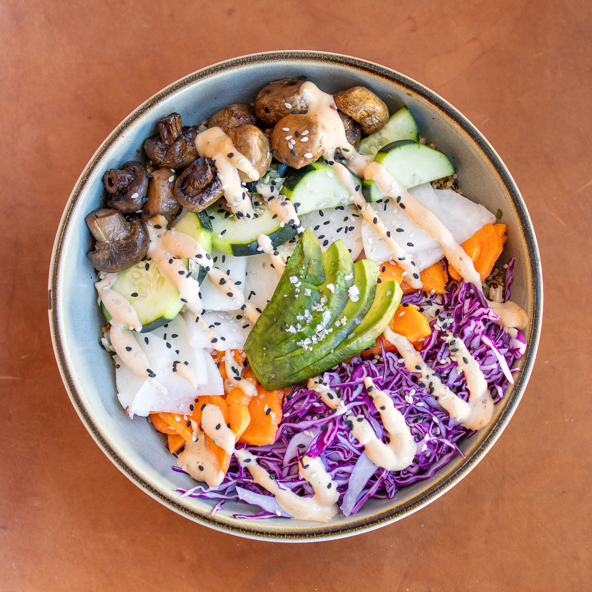 Colorful vegan grain bowl with tahini dressing