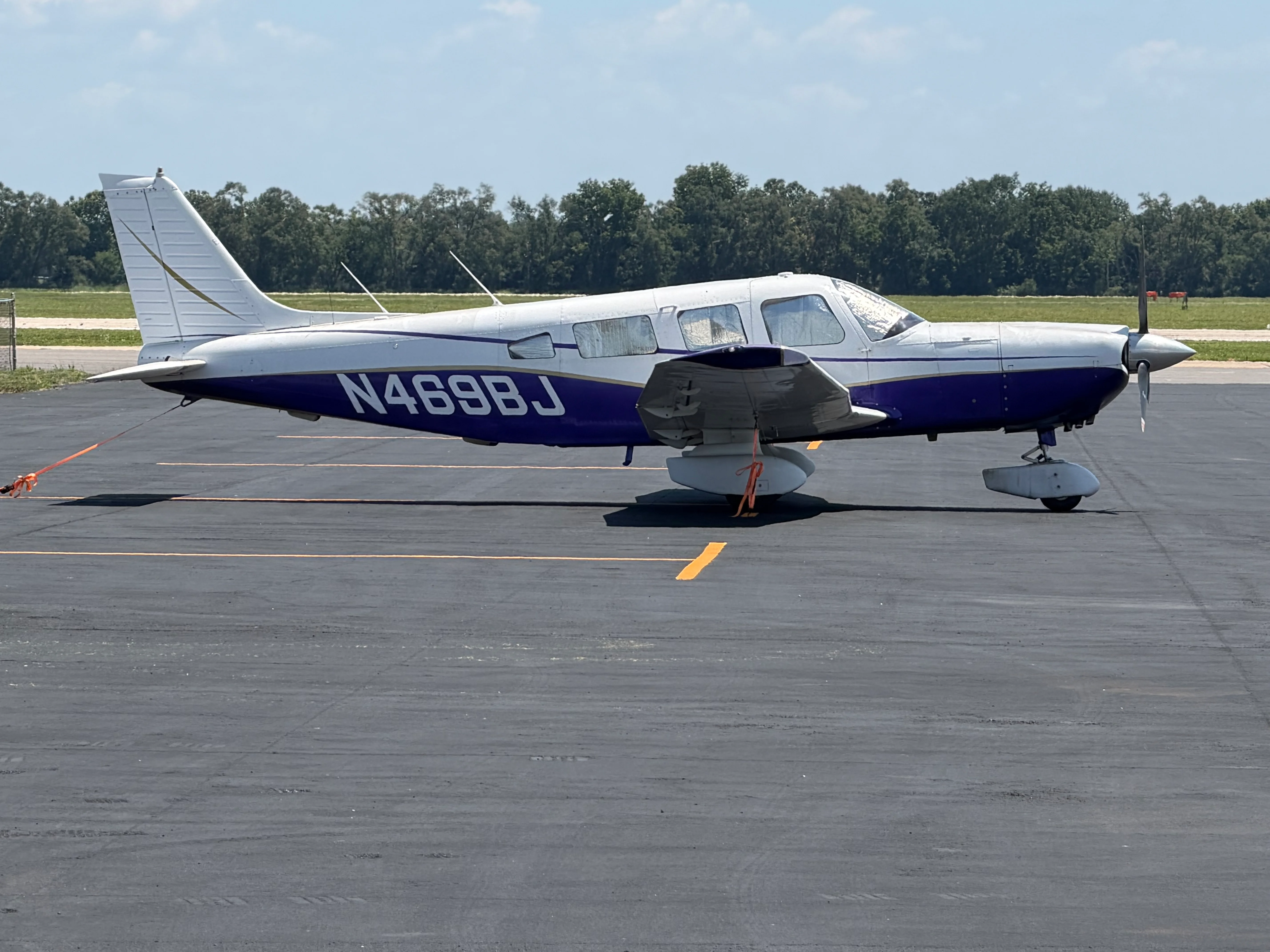 Single-engine aircraft parked on tarmac