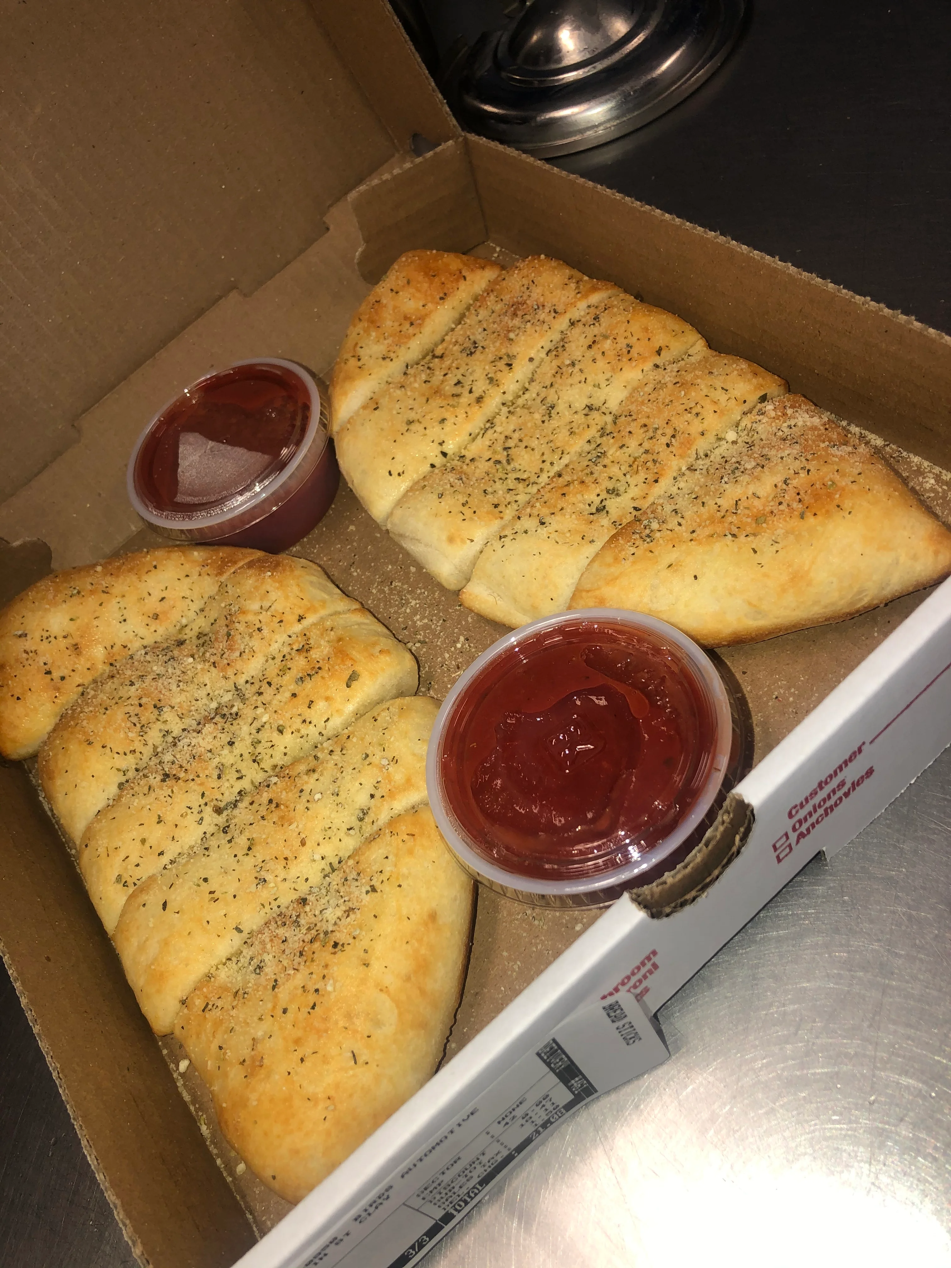 Garlic breadsticks served with marinara sauce