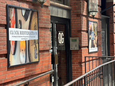 Exterior view of Clock Restoration restaurant with signage and brick facade
