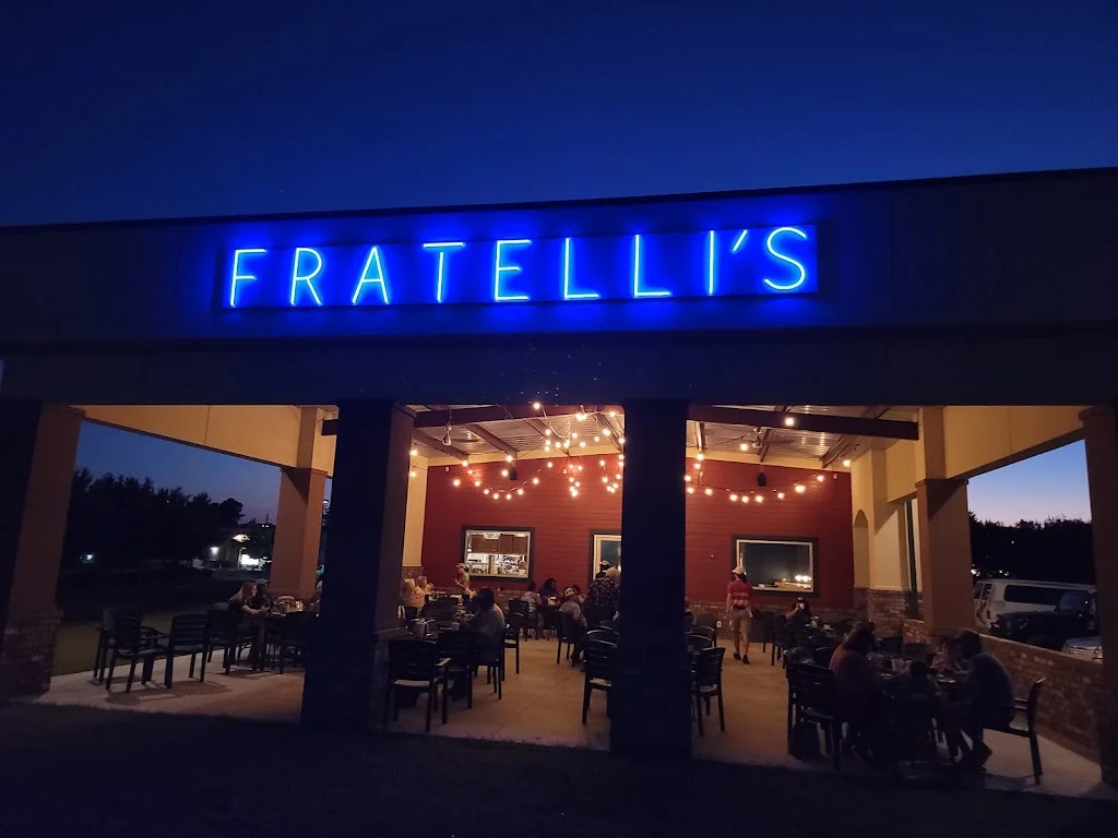 Outdoor dining area of Fratelli's restaurant at night
