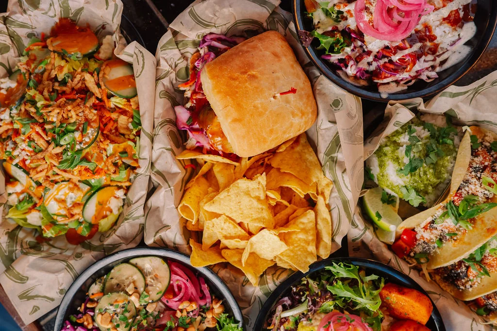 Colorful Mexican feast with tacos, nachos, and fresh salads