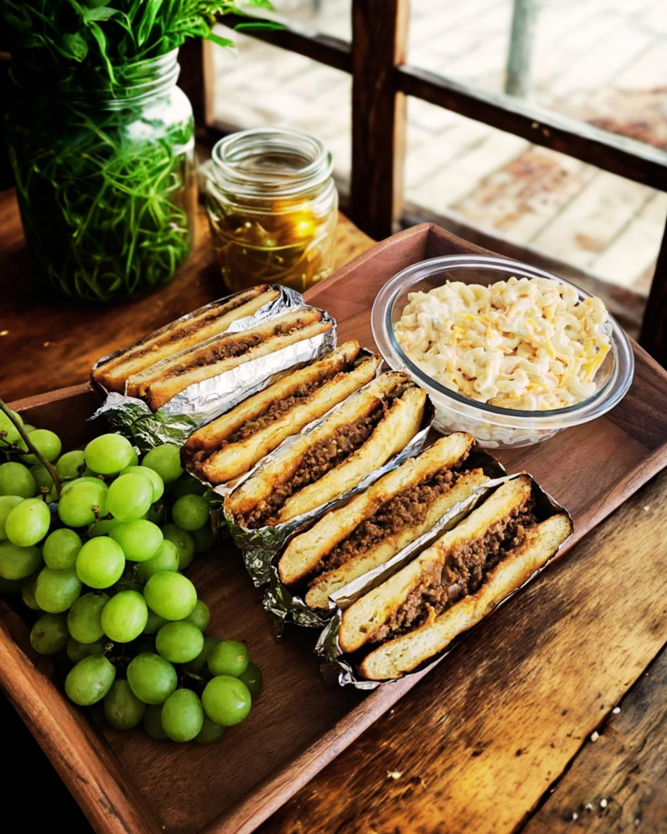 Savory stuffed sandwiches with coleslaw and grapes