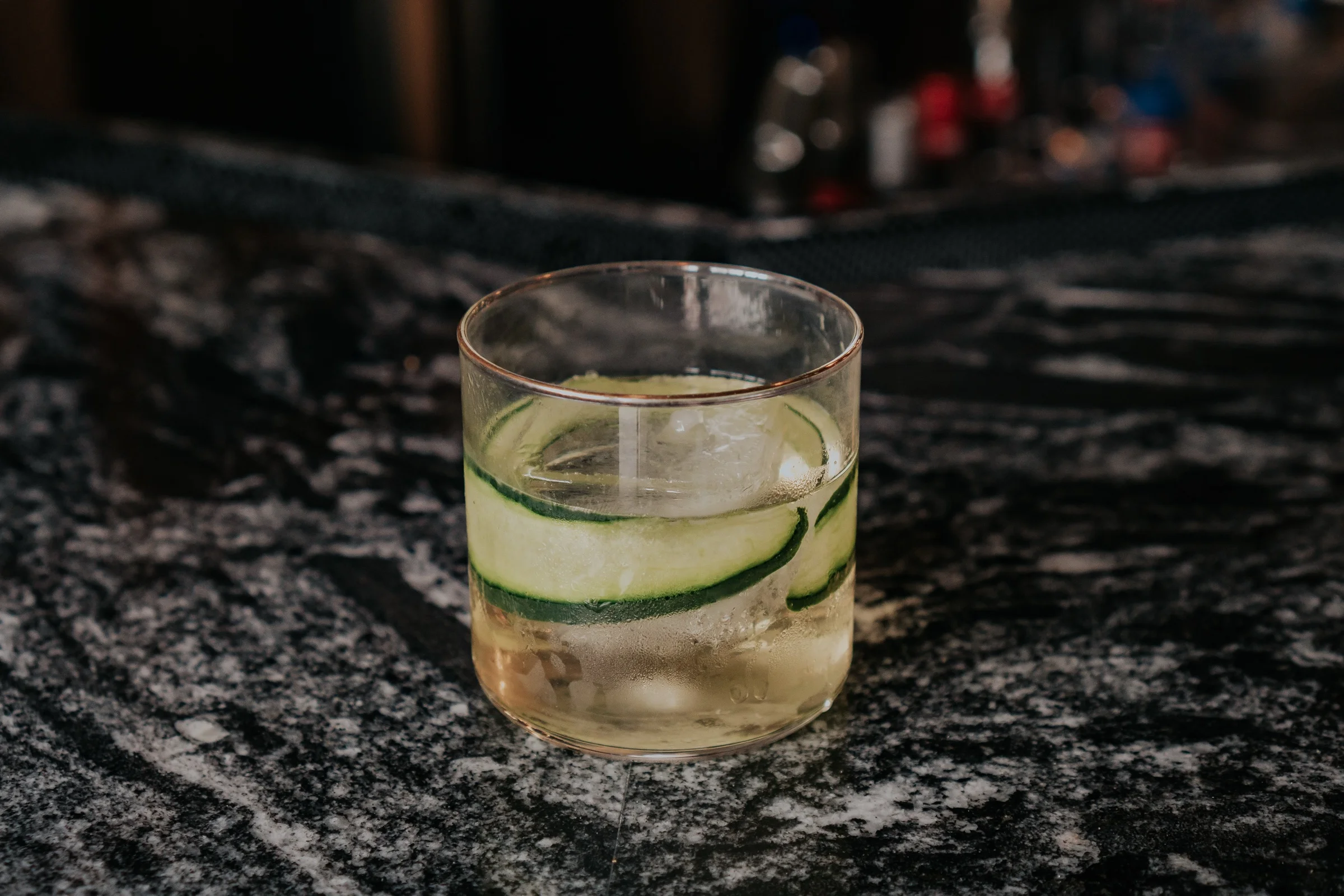 Drink with cucumber ribbons on the bar at Castro Indian Restaurant