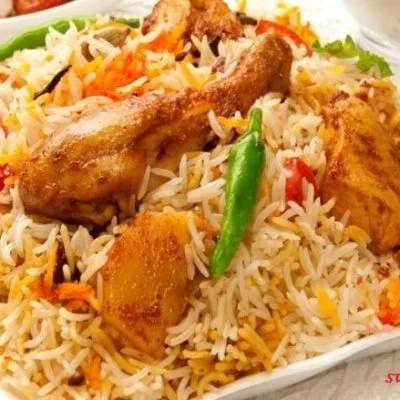 Flavorful chicken biryani served with spices and herbs