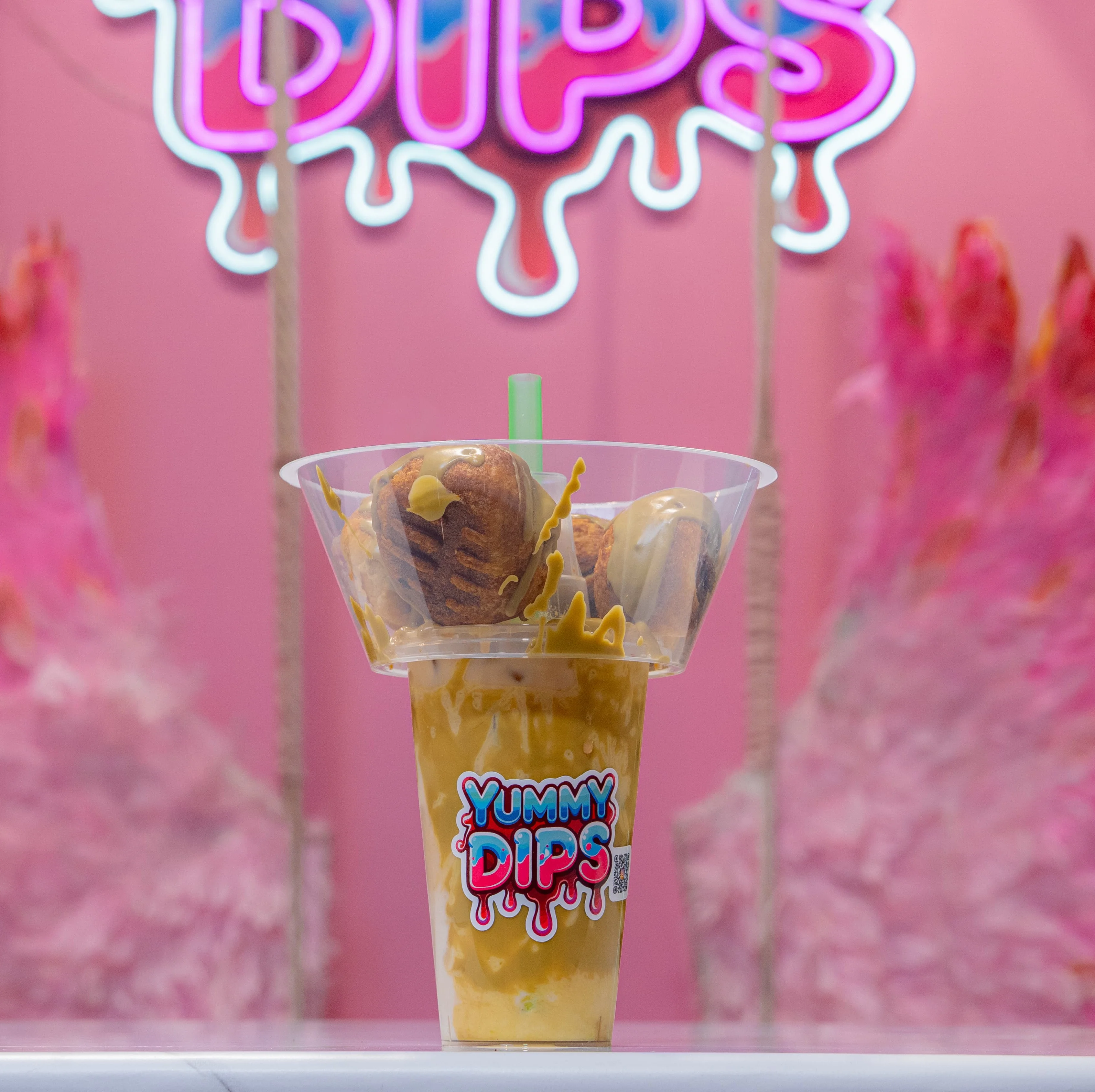 Colorful dessert drink with mini donuts and caramel drizzle
