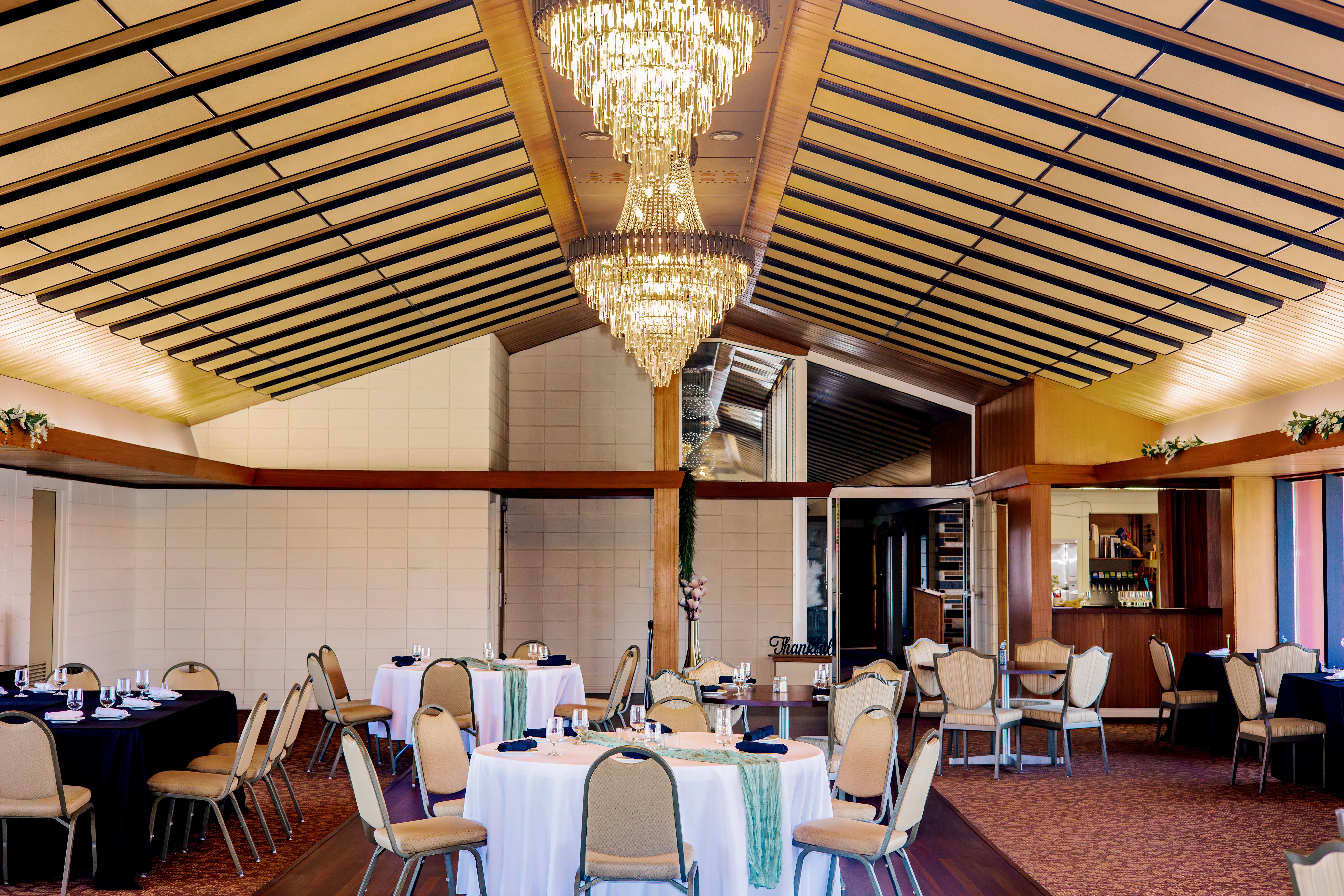 Elegant restaurant interior with chandeliers and round tables