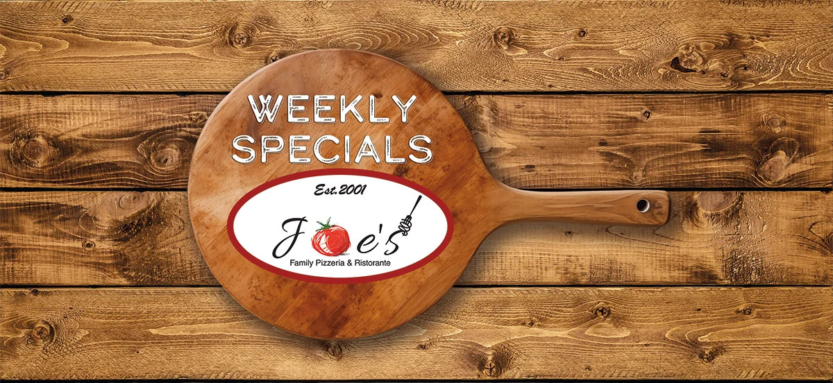 Wooden pizza peel with weekly specials sign for a family pizzeria