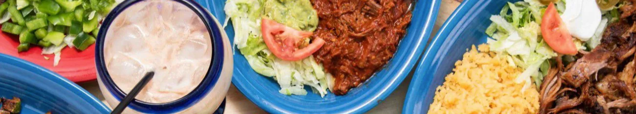 Colorful Mexican platter with shredded beef, guacamole, and rice