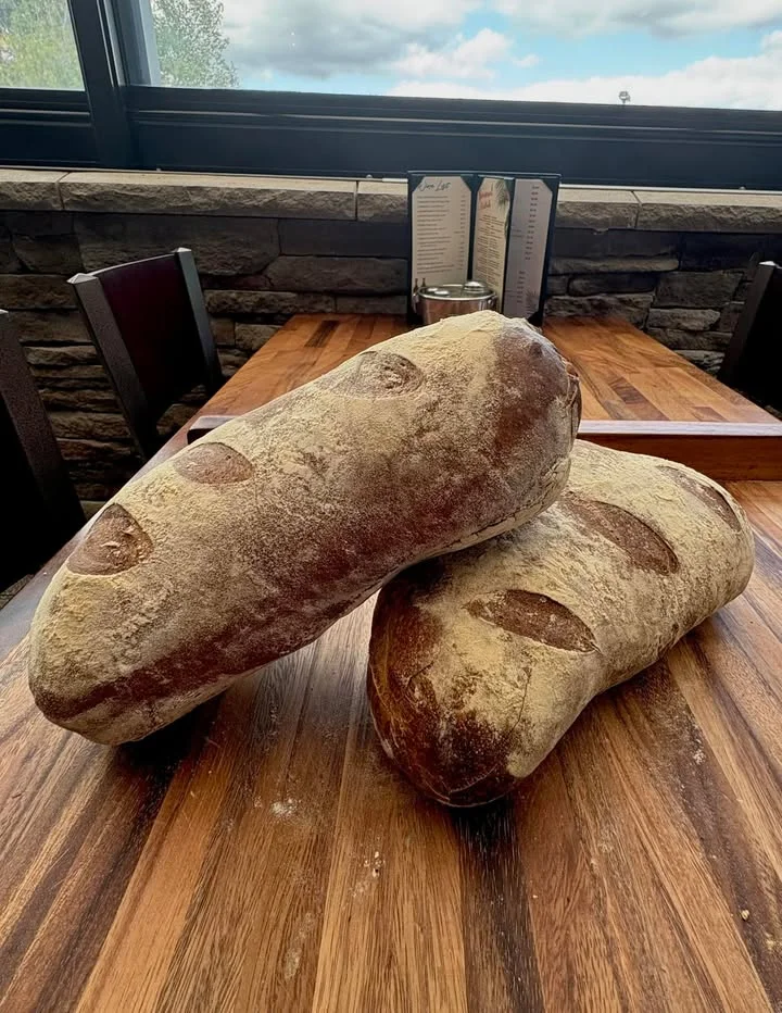 Artisan rustic bread loaves on a wooden table